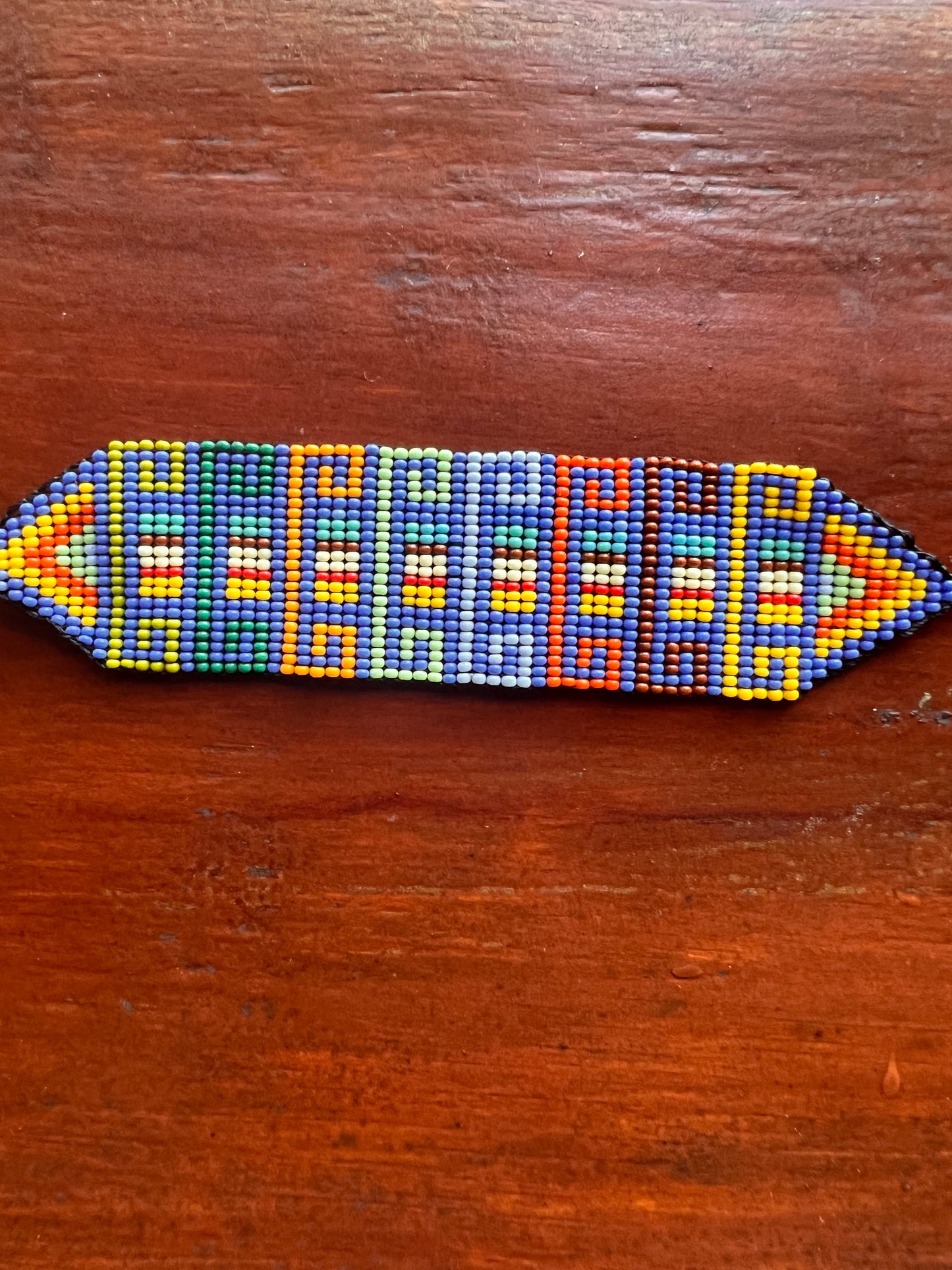 Light blue bracelet with multicoloured patterns Inga Kamentsa 4 cm x 15 cm