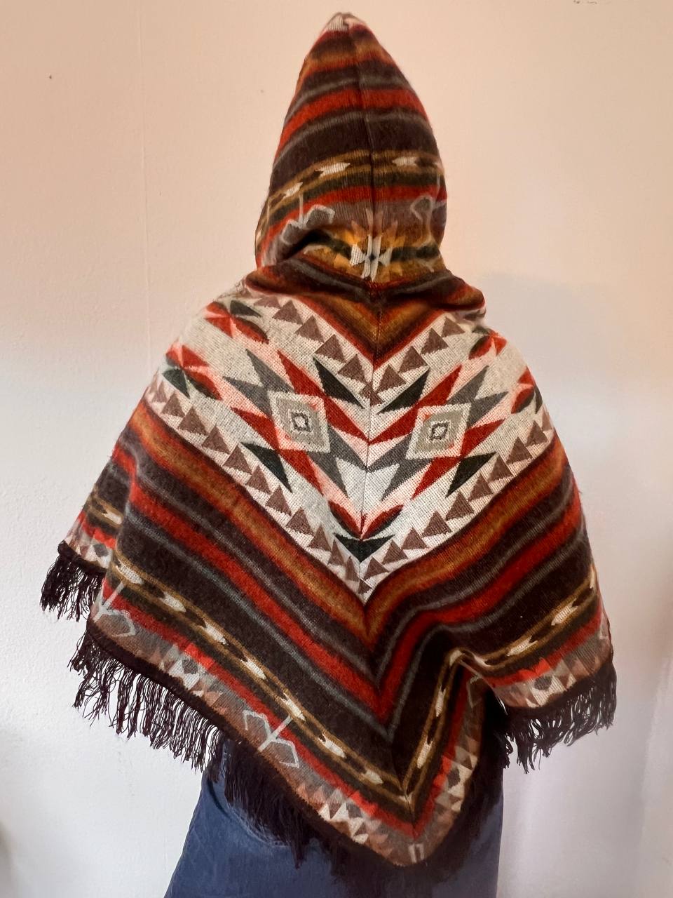 Small multicoloured poncho with patterns