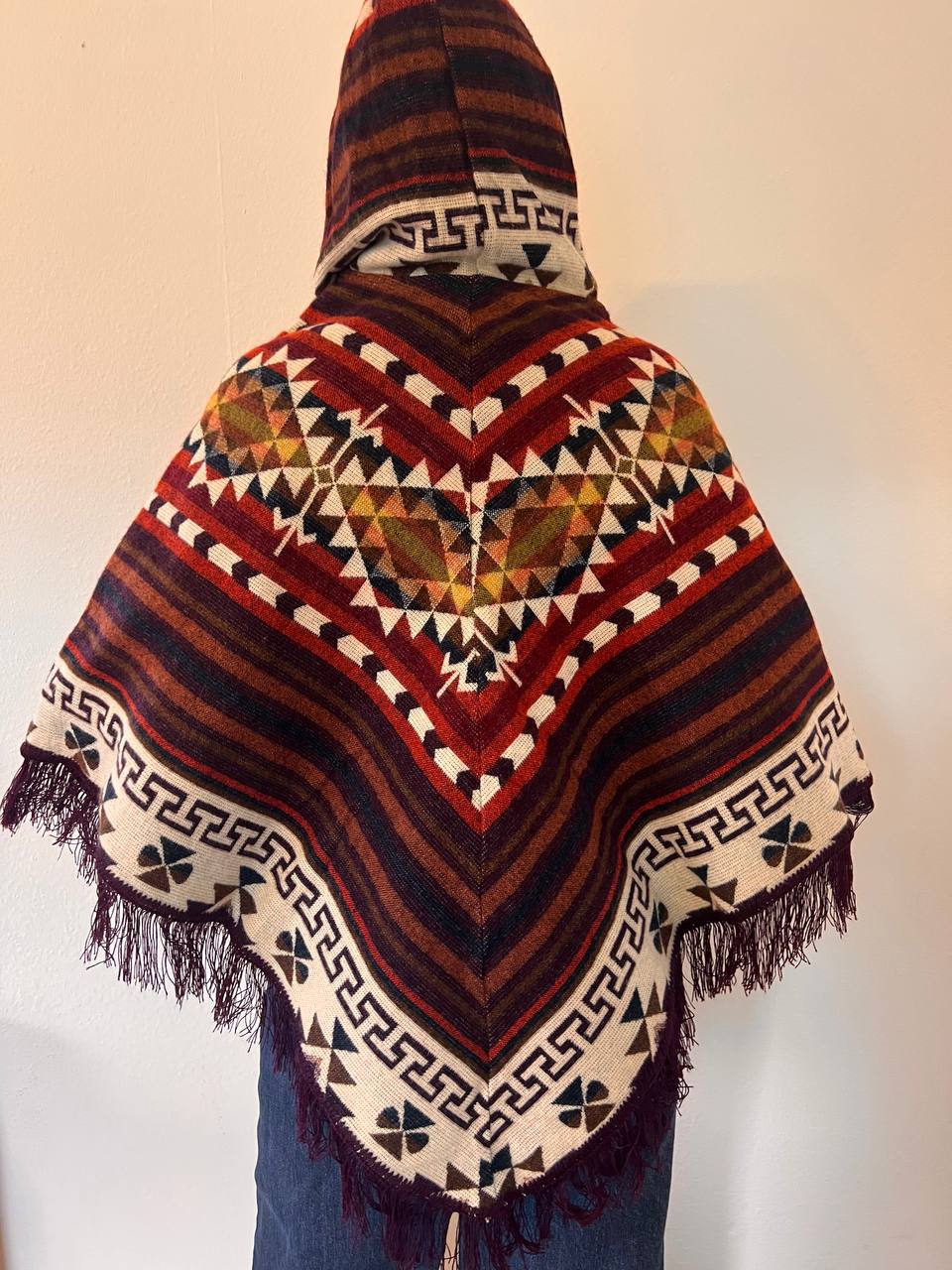 Brown winter poncho with red patterns