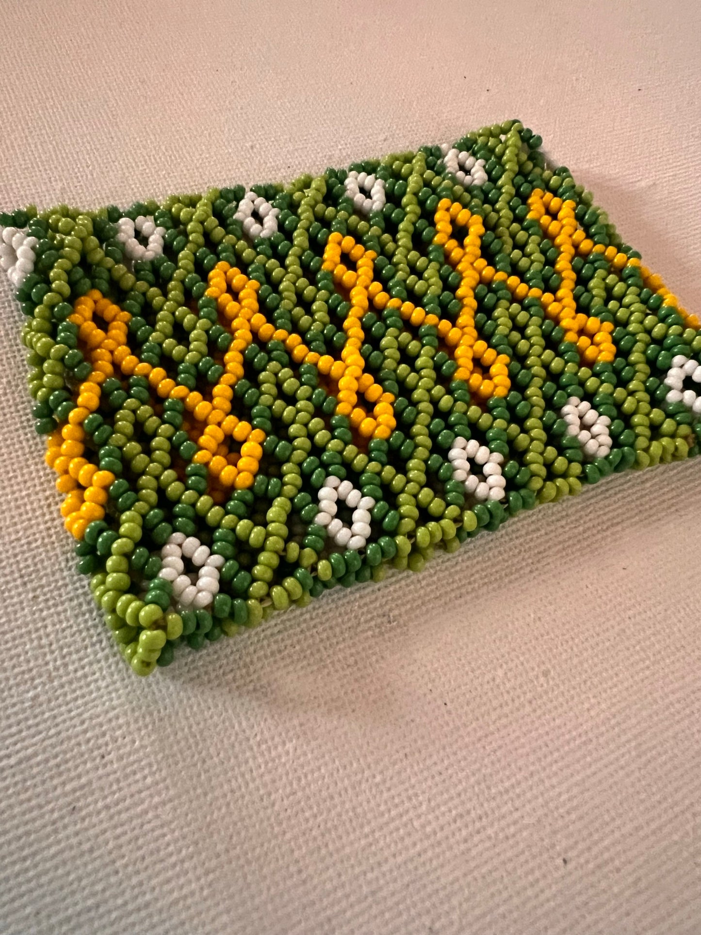 Green Huni Kuin bracelet with yello and white patterns