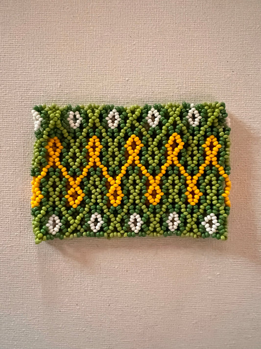 Green Huni Kuin bracelet with yello and white patterns