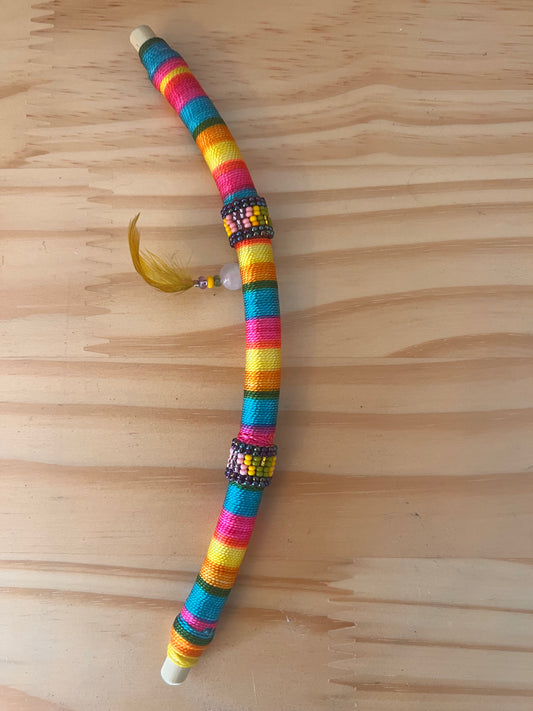 Rainbow-coloured bendable Tepi with feather