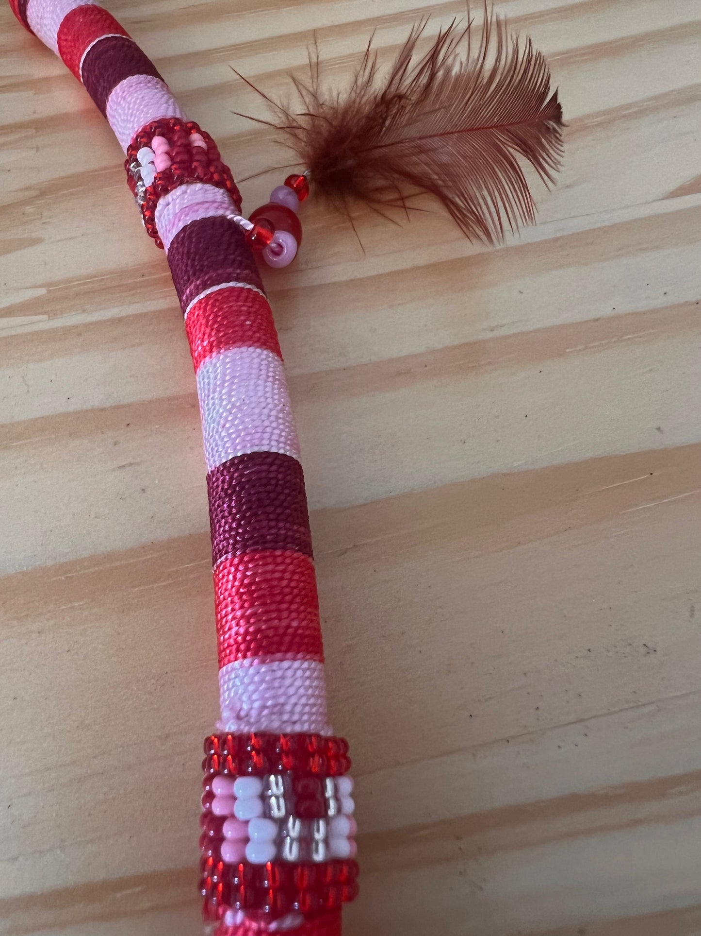 Red bendable Tepi with feather