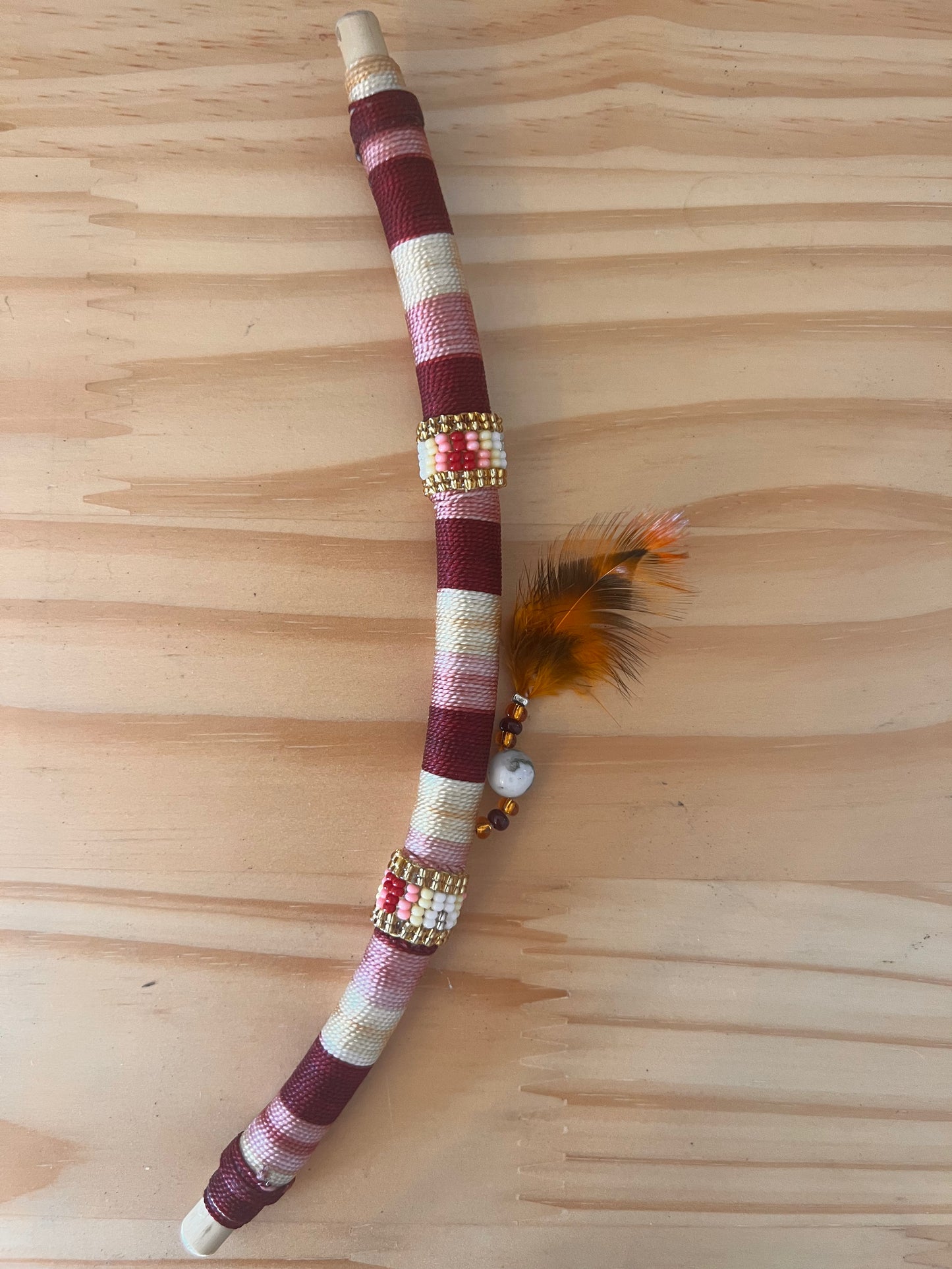 Red bendable Tepi with feather