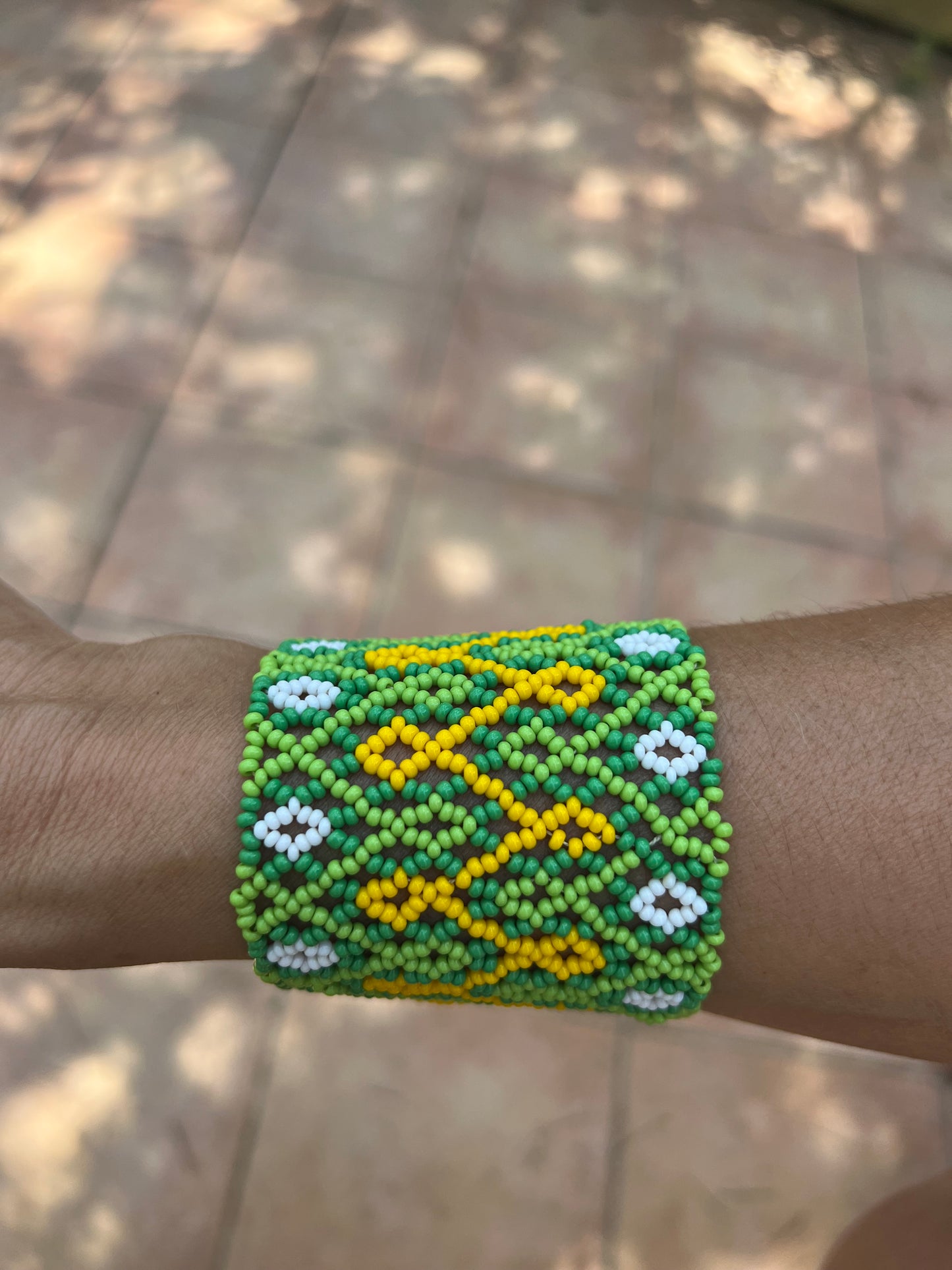 Green Huni Kuin bracelet with yello and white patterns