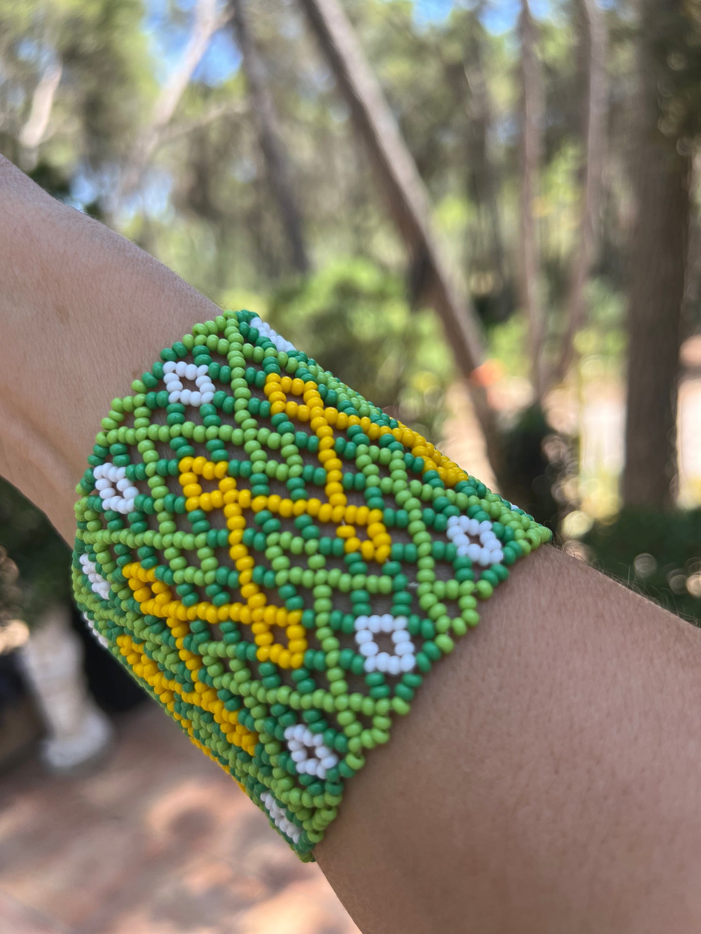 Green Huni Kuin bracelet with yello and white patterns