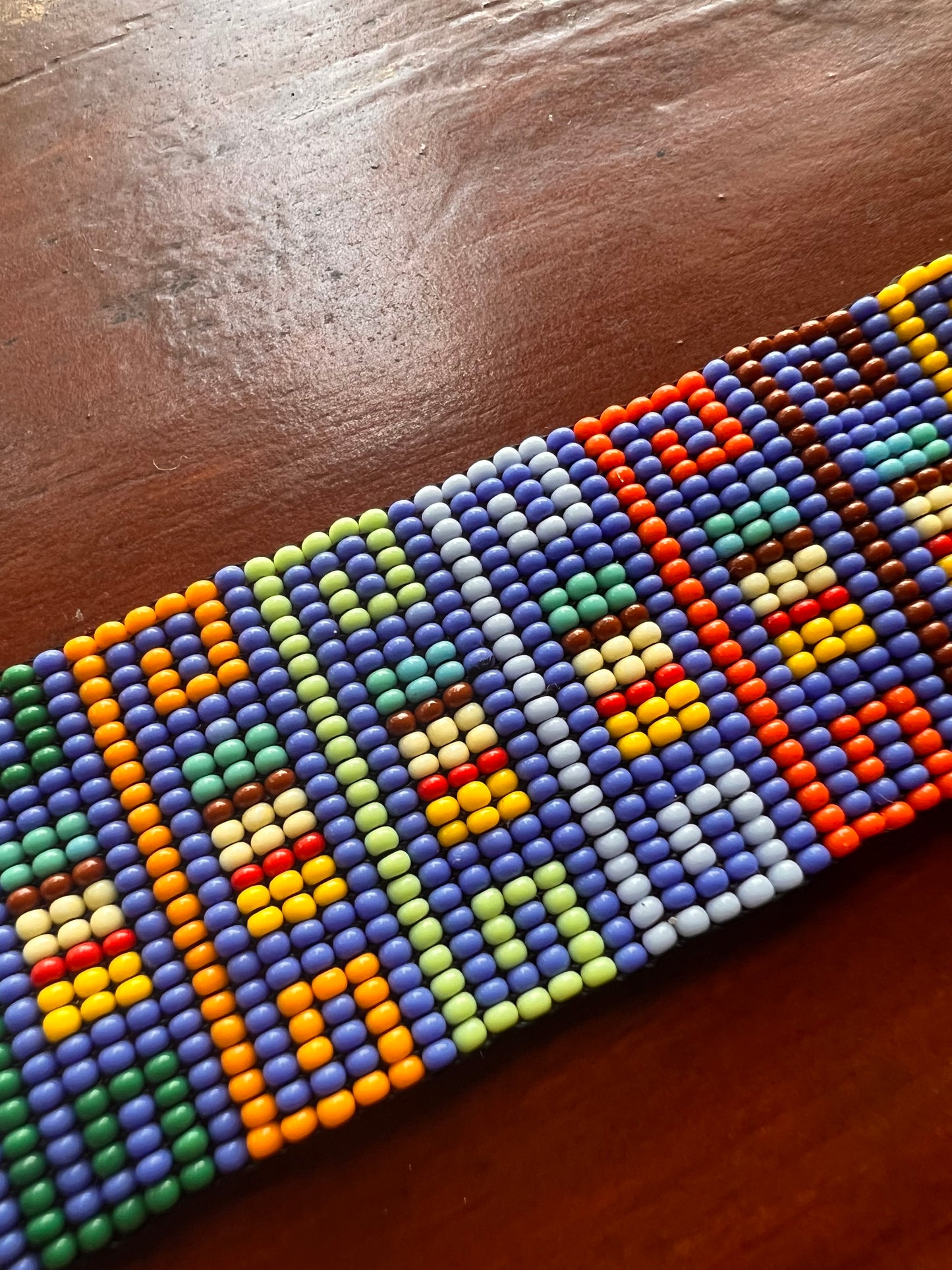 Light blue bracelet with multicoloured patterns Inga Kamentsa 4 cm x 15 cm