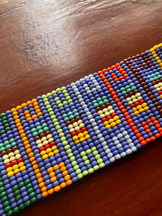 Light blue bracelet with multicoloured patterns Inga Kamentsa 4 cm x 15 cm