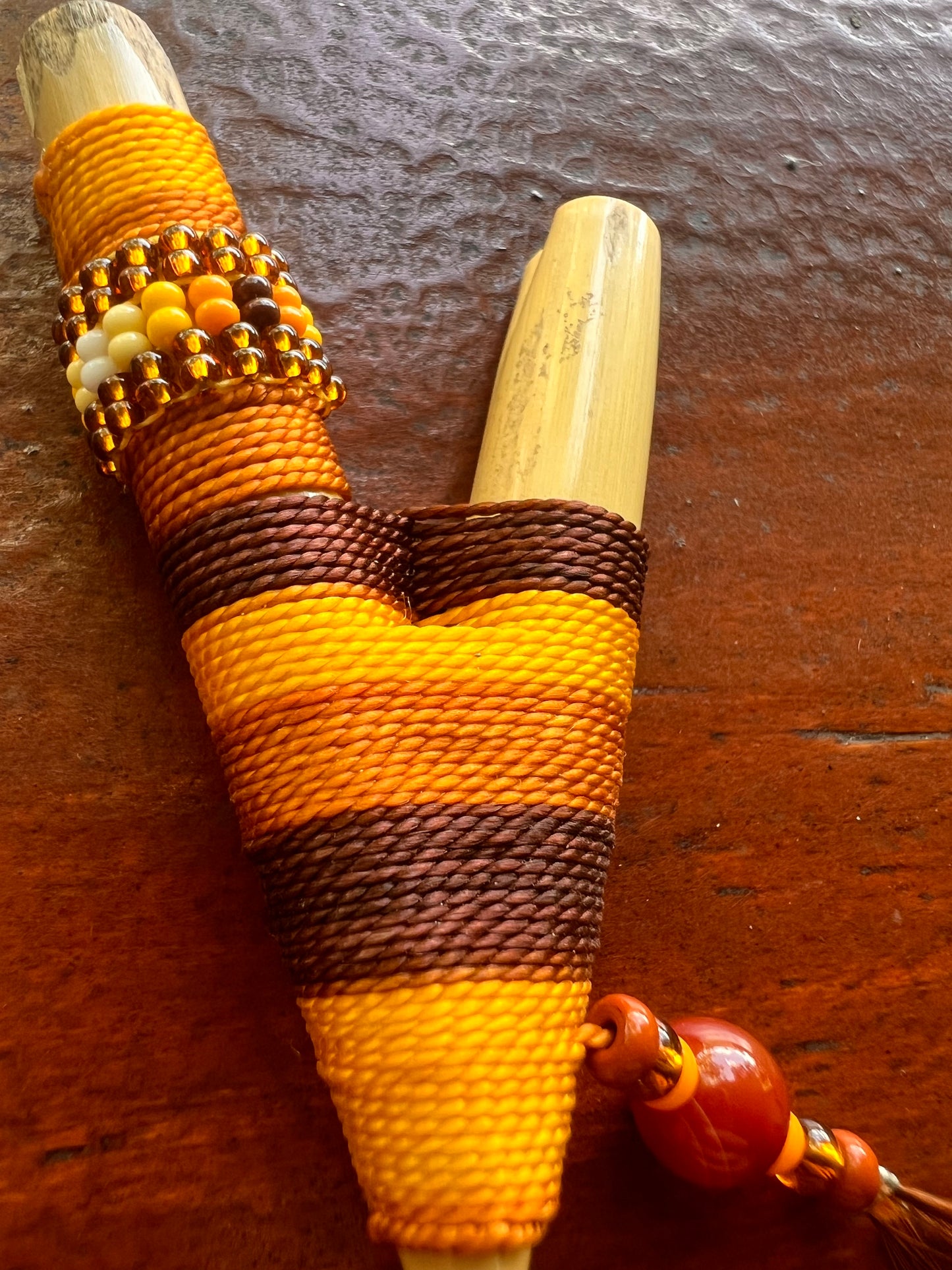 Brown-beige Bamboo Kuripe with feather and pearls