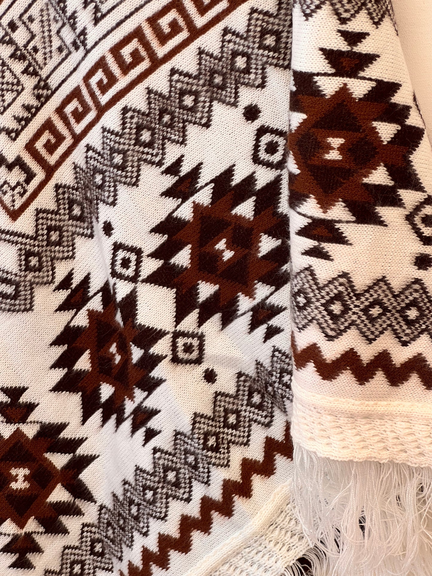 White winter poncho with brown patterns