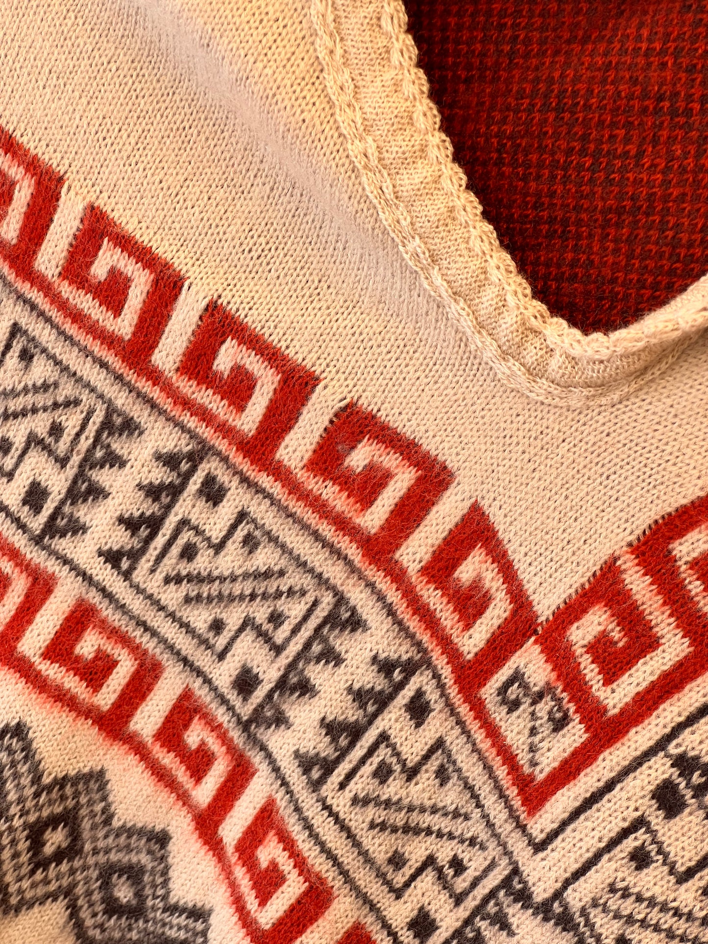 White winter poncho with red/grey patterns