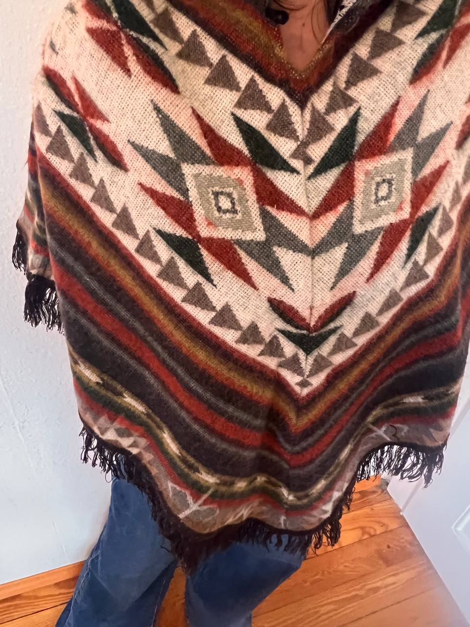 Small multicoloured poncho with patterns