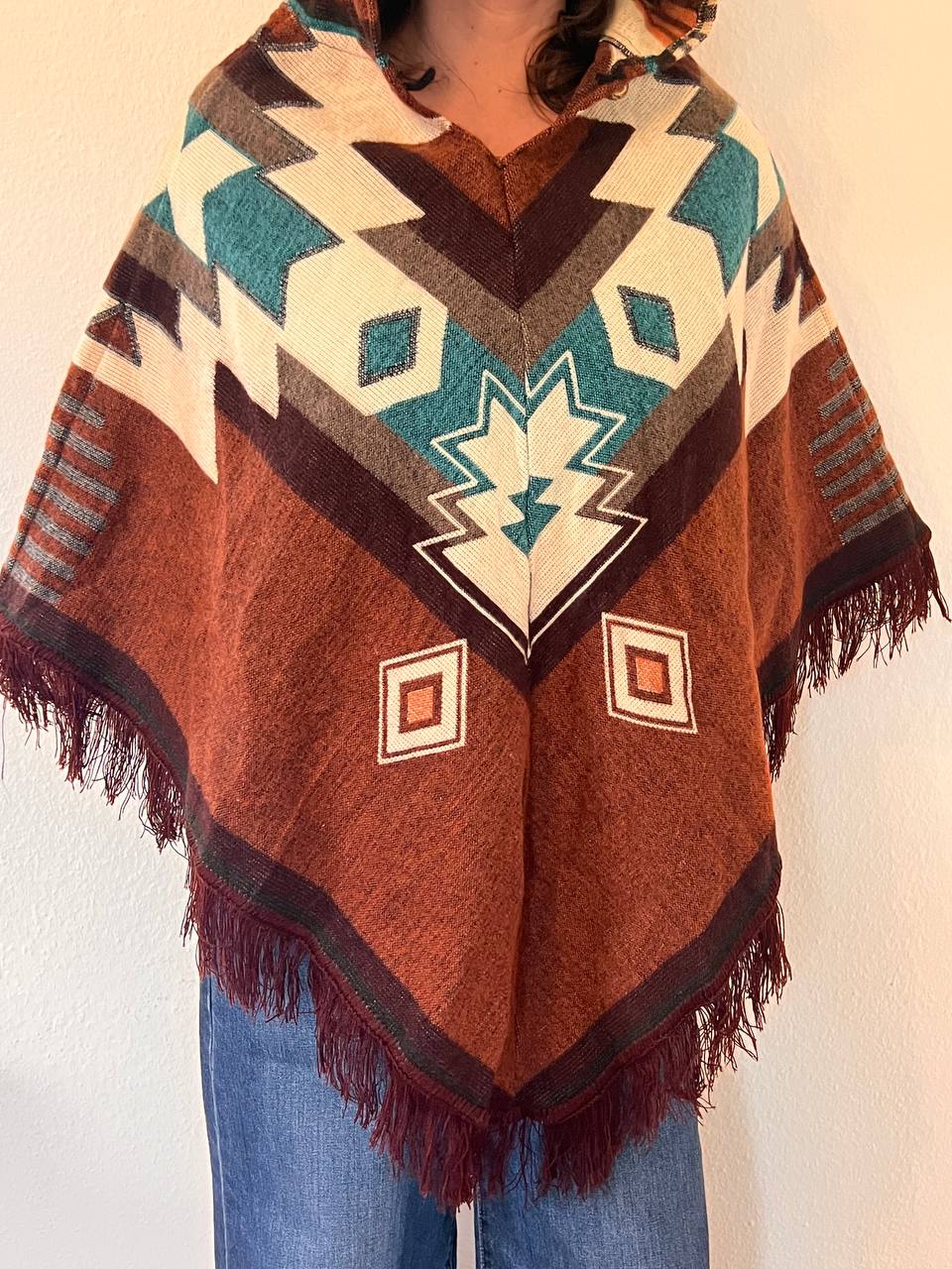 Brown winter poncho with light blue patterns