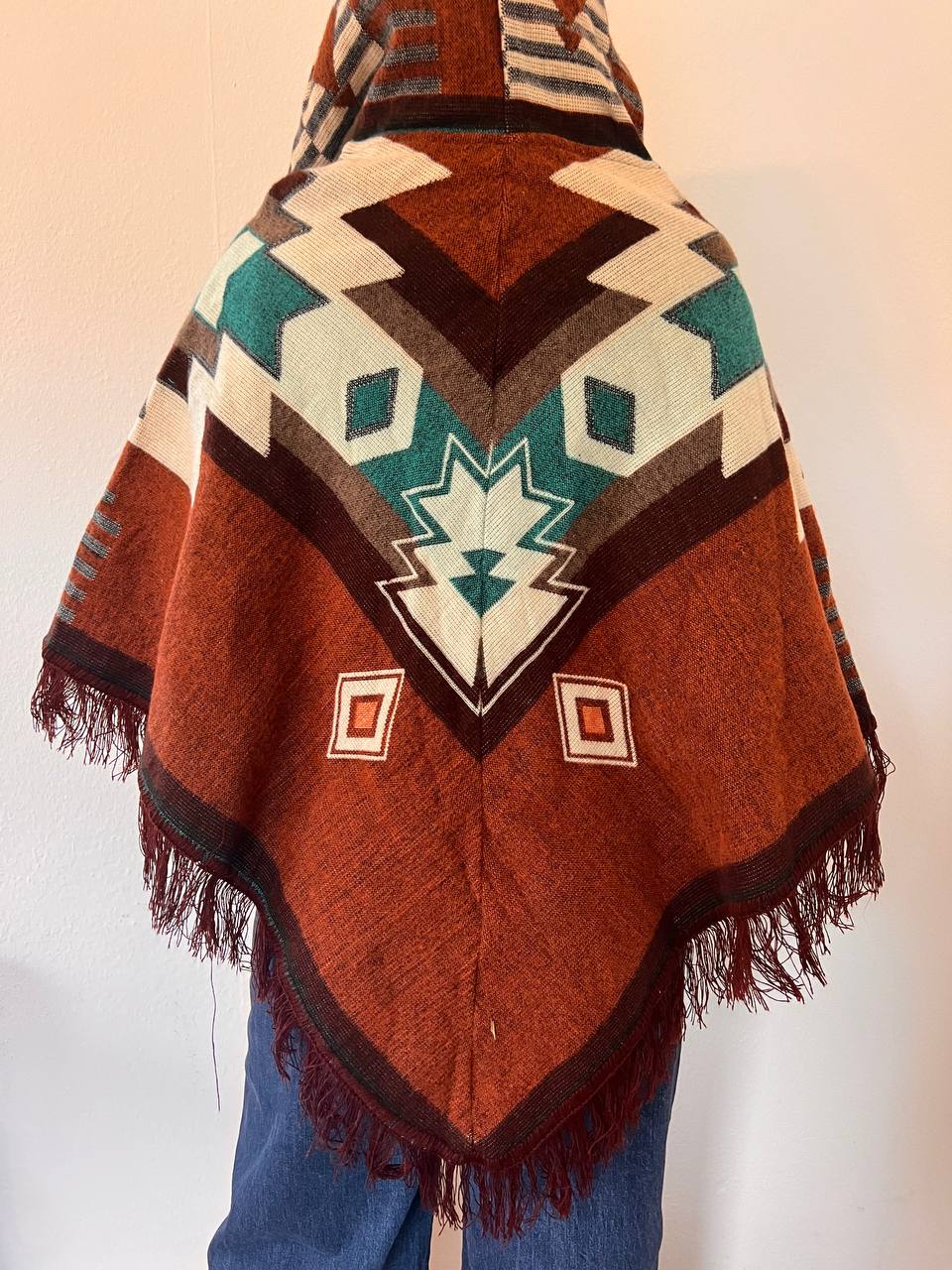 Brown winter poncho with light blue patterns