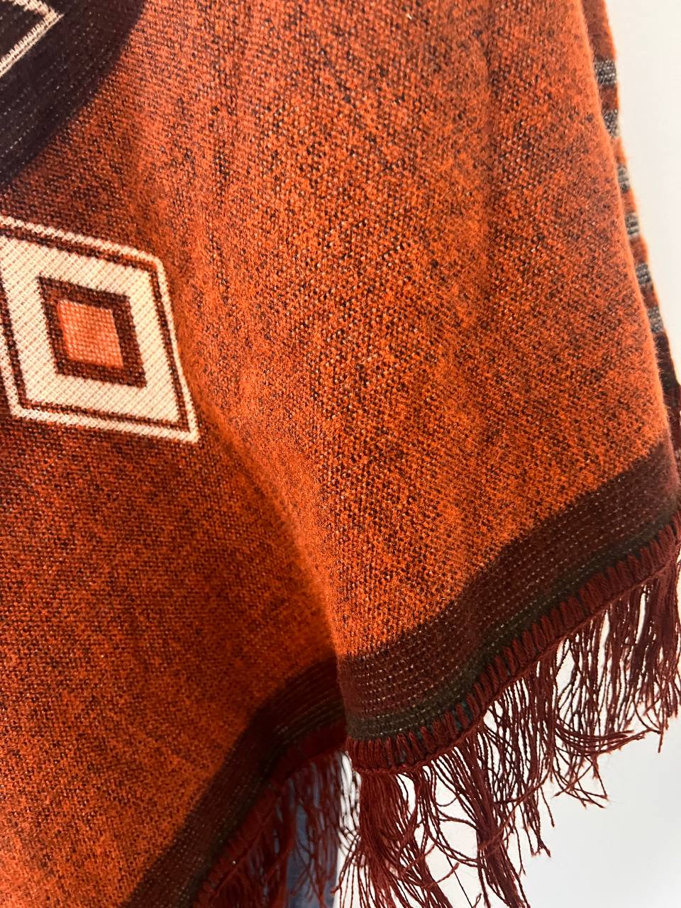 Brown winter poncho with light blue patterns