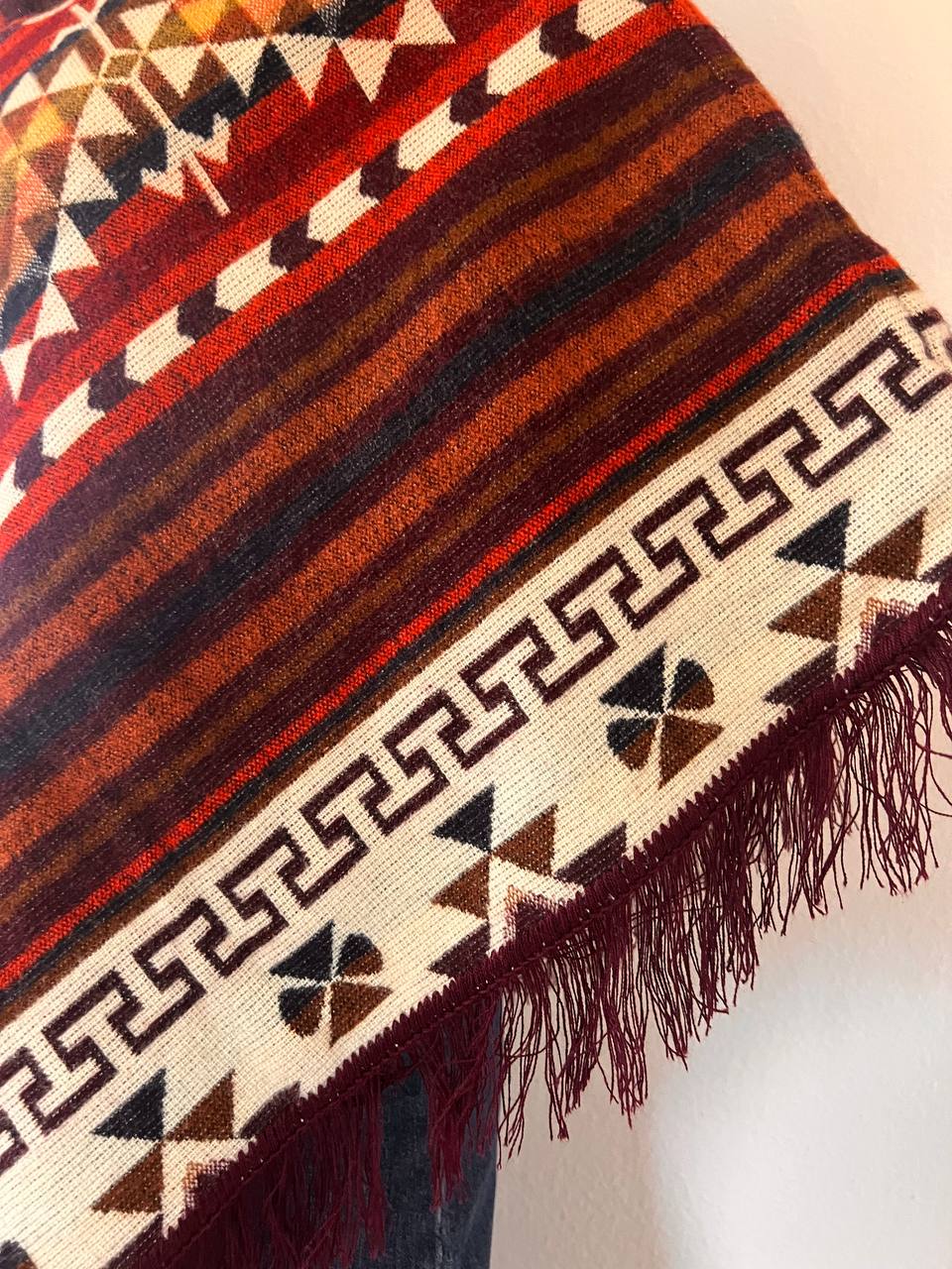 Brown winter poncho with red patterns