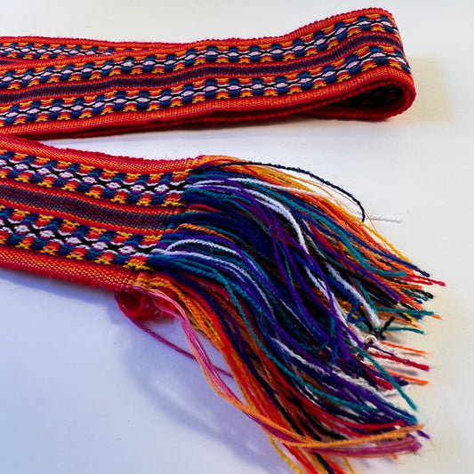 Dark red ceremony belt with blue and rainbow colored patterns 7 cm x 200 cm