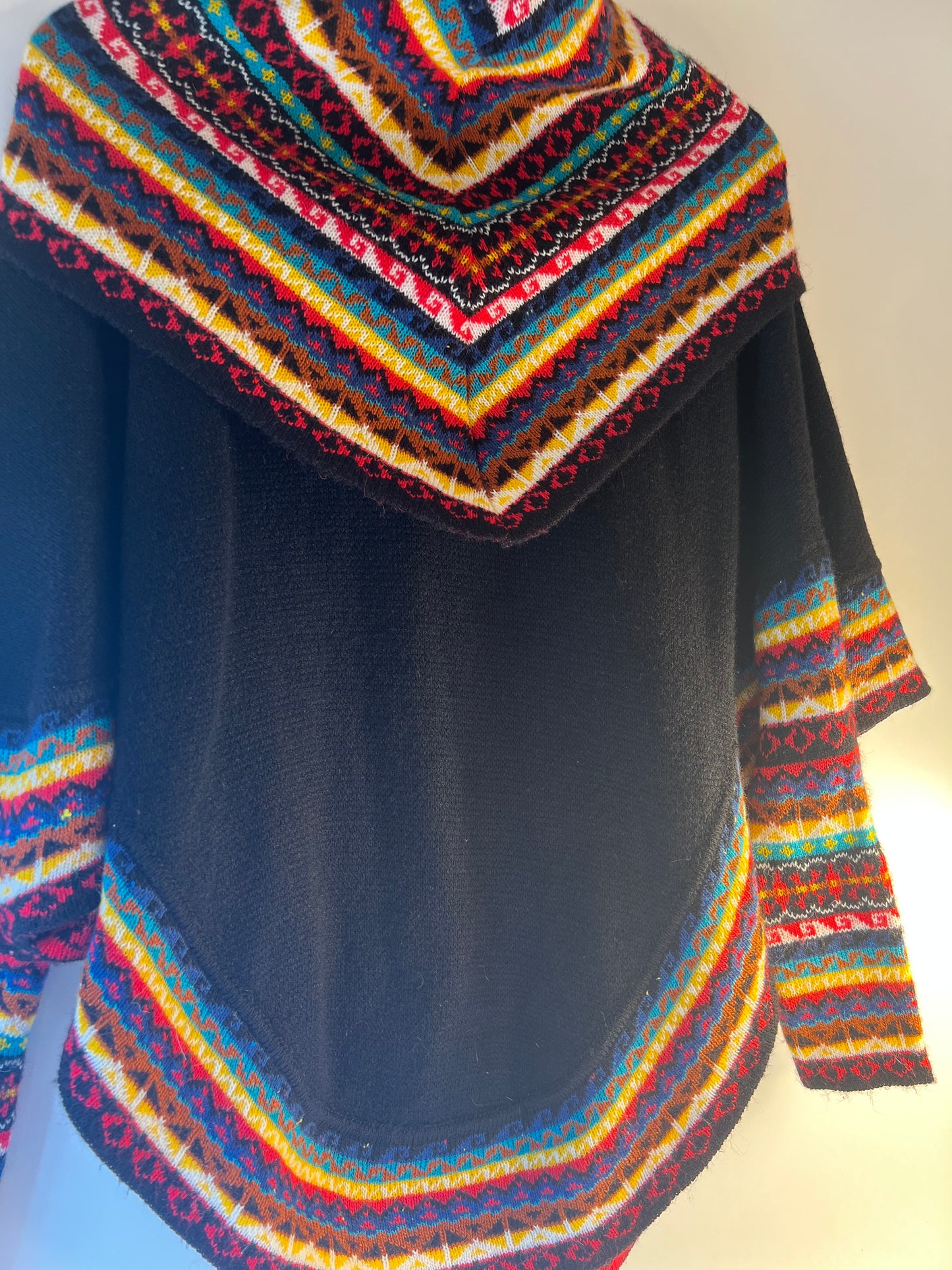 Black winter poncho sweater with multicoloured neack and sleeves